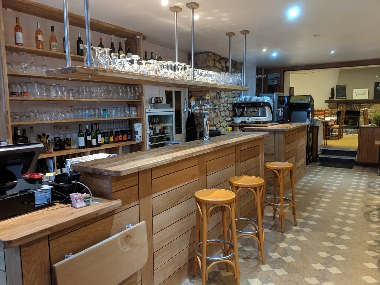 Le bar en bois et ses tabourets